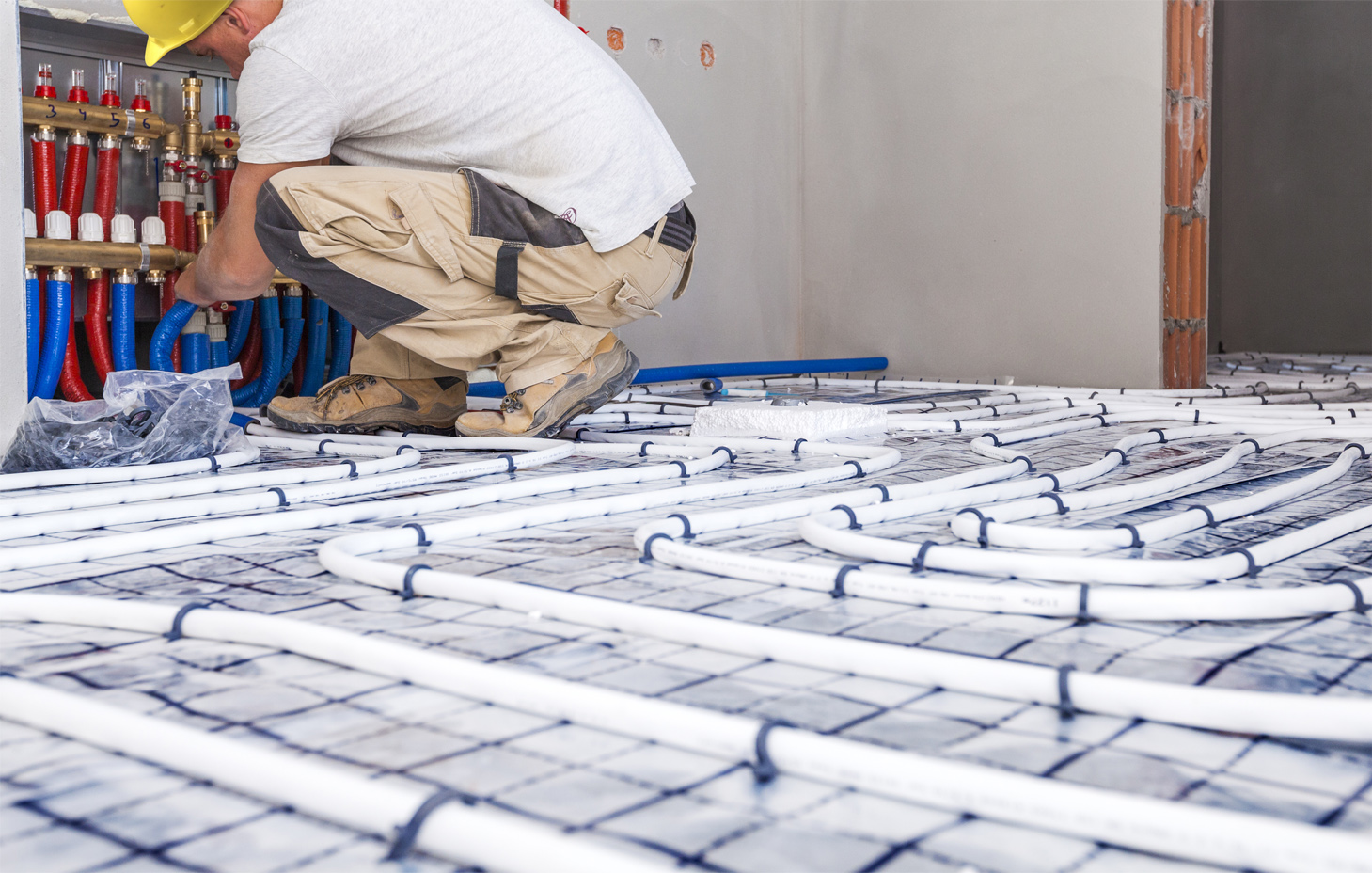 A man installing heated flooring